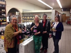 Amore Cucina guide Agata Commisso and class participants shopping for wine